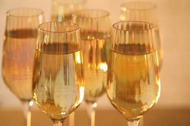 Glasses of champagne on blurred background, closeup