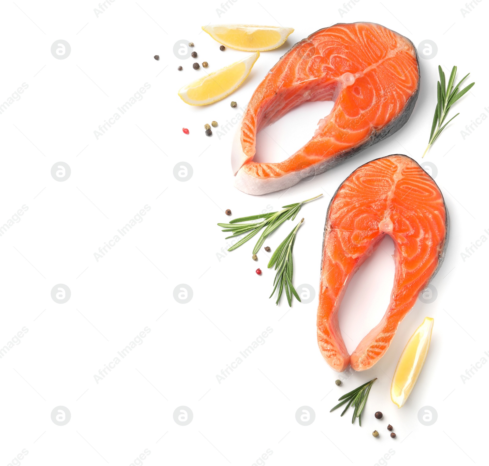 Photo of Fresh raw salmon steaks with rosemary and lemon on white background, top view