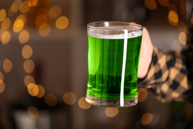 Closeup view of man with green beer in pub, space for text. St.Patrick's Day celebration