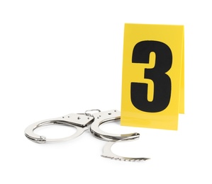 Photo of Handcuffs and crime scene marker with number three isolated on white