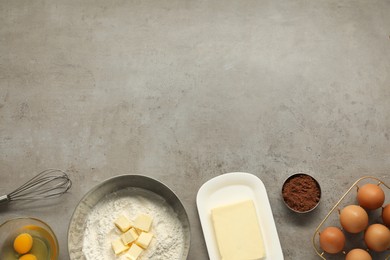 Photo of Flat lay composition with fresh butter and other products on grey textured table. Space for text