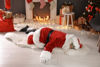 Photo of Authentic Santa Claus lying on floor indoors