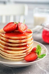 Photo of Plate with pancakes and berries on table, closeup