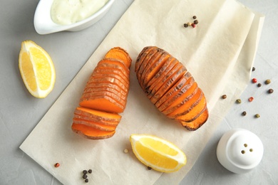 Flat lay composition with baked sweet potatoes on grey background