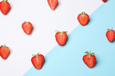 Flat lay composition with ripe strawberries on color background