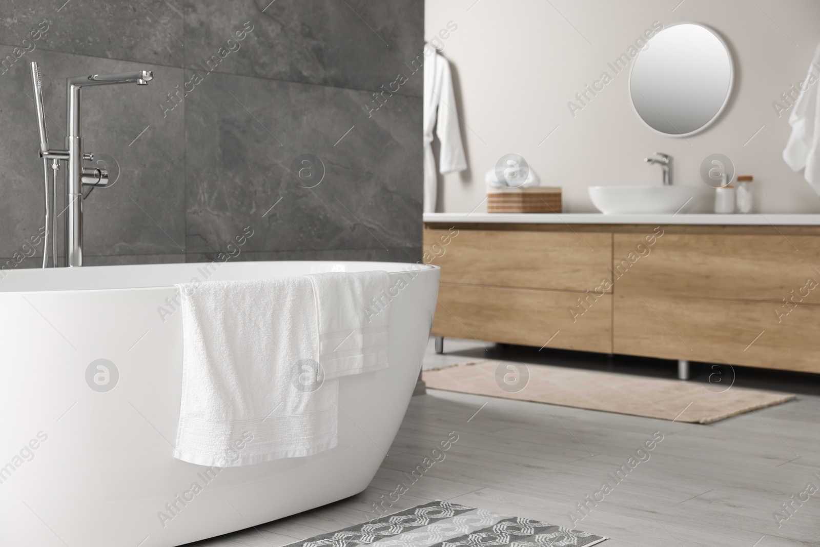 Photo of Fresh white towels on tub in bathroom. Space for text