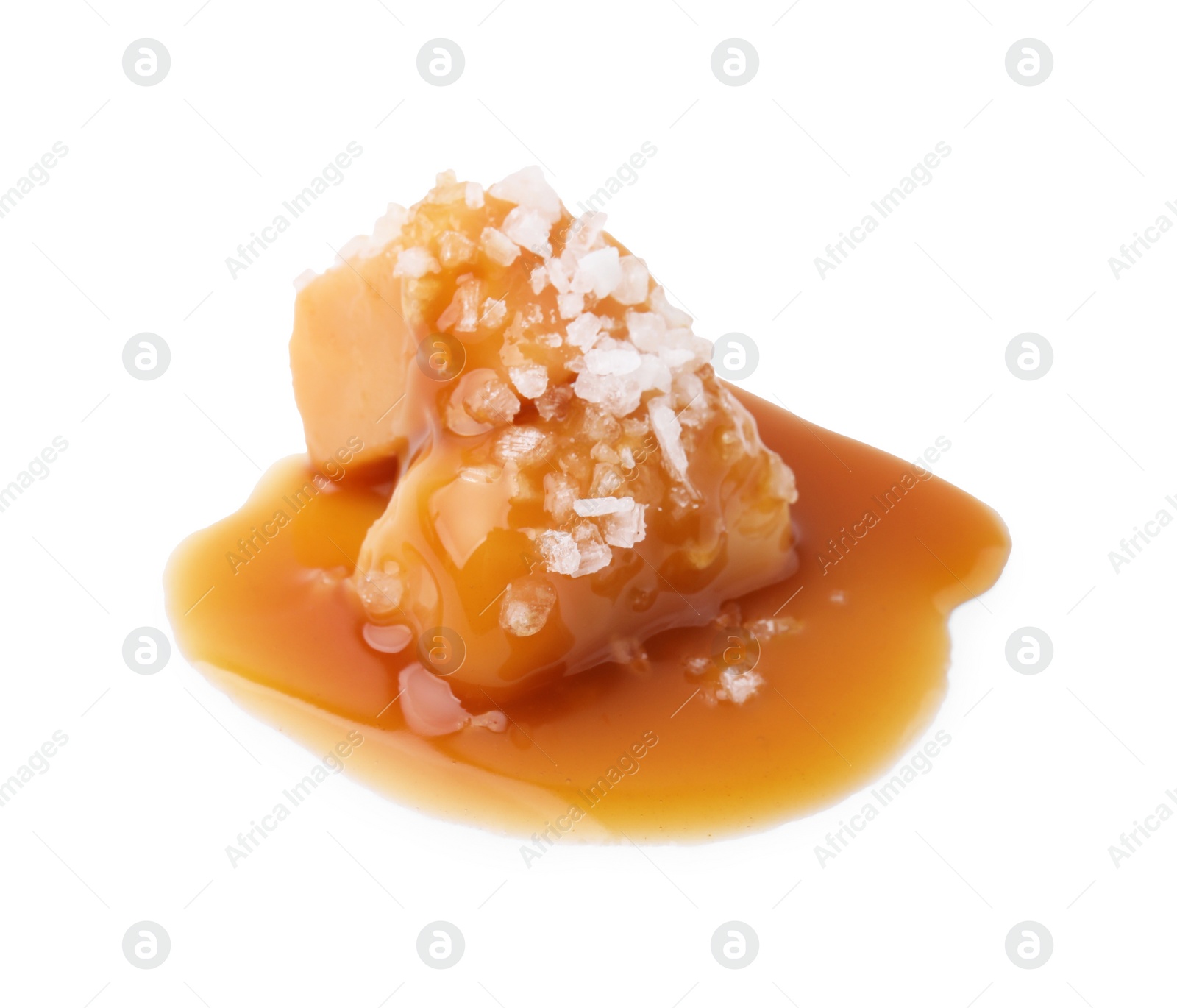 Photo of Yummy caramel candies and sea salt isolated on white