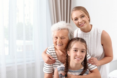 Happy sisters and their grandmother at home