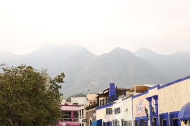 Photo of San Pedro Garza Garcia, Mexico – February 8, 2023: View on street with beautiful buildings and mountains