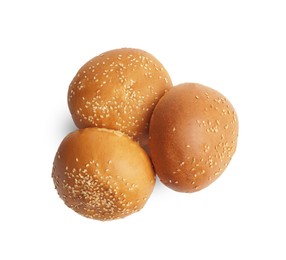 Photo of Fresh tasty buns with sesame seeds isolated on white, top view