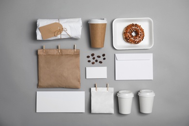 Photo of Flat lay composition with items for mock up design on gray background. Food delivery service