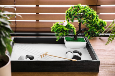 Beautiful miniature zen garden on wooden table