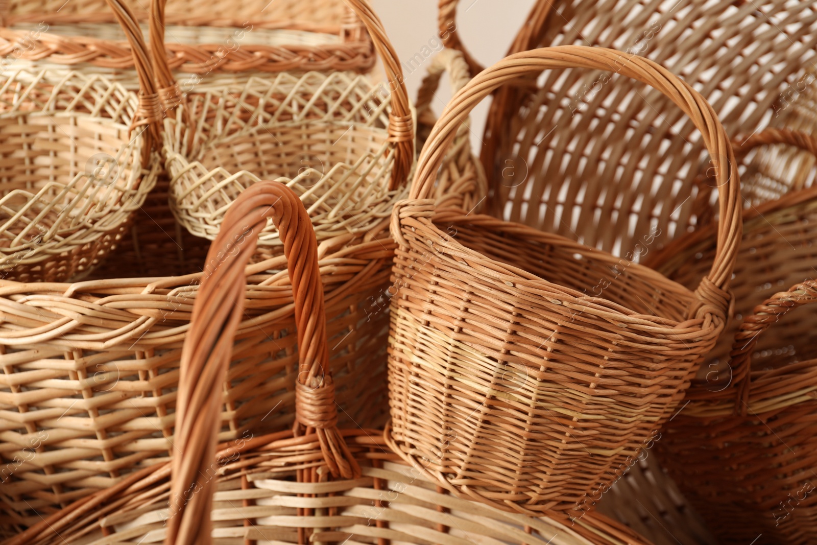 Photo of Many different wicker baskets made of natural material as background