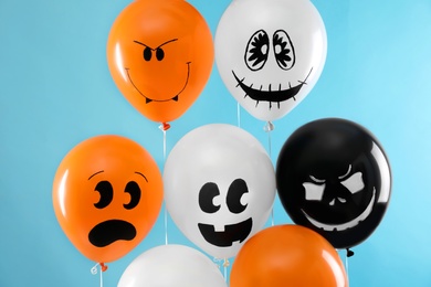 Photo of Color balloons for Halloween party on blue background