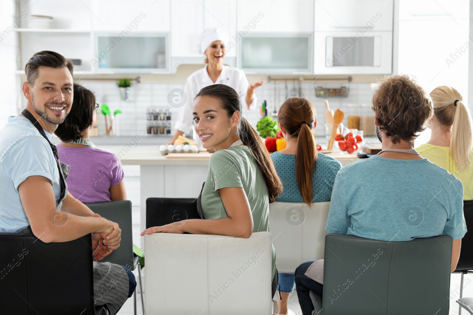 Photo of Group of people and female chef at cooking classes