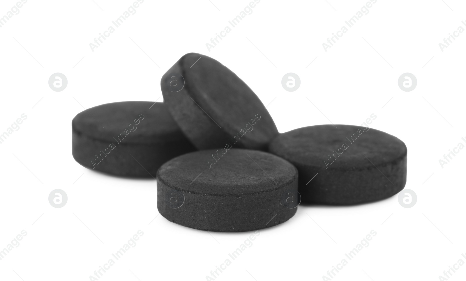 Photo of Activated charcoal pills on white background. Potent sorbent