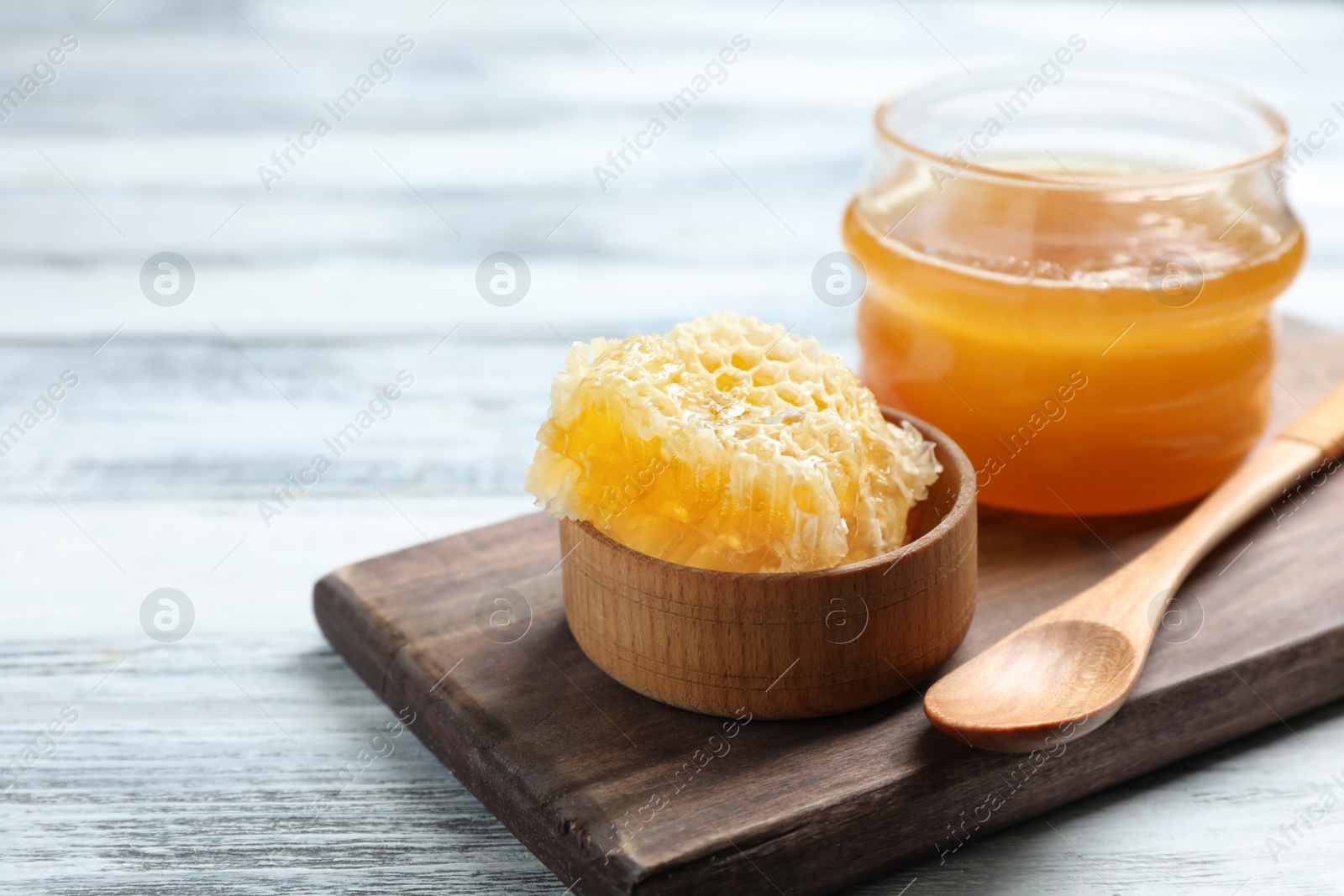 Photo of Composition with tasty fresh honeycomb on wooden board