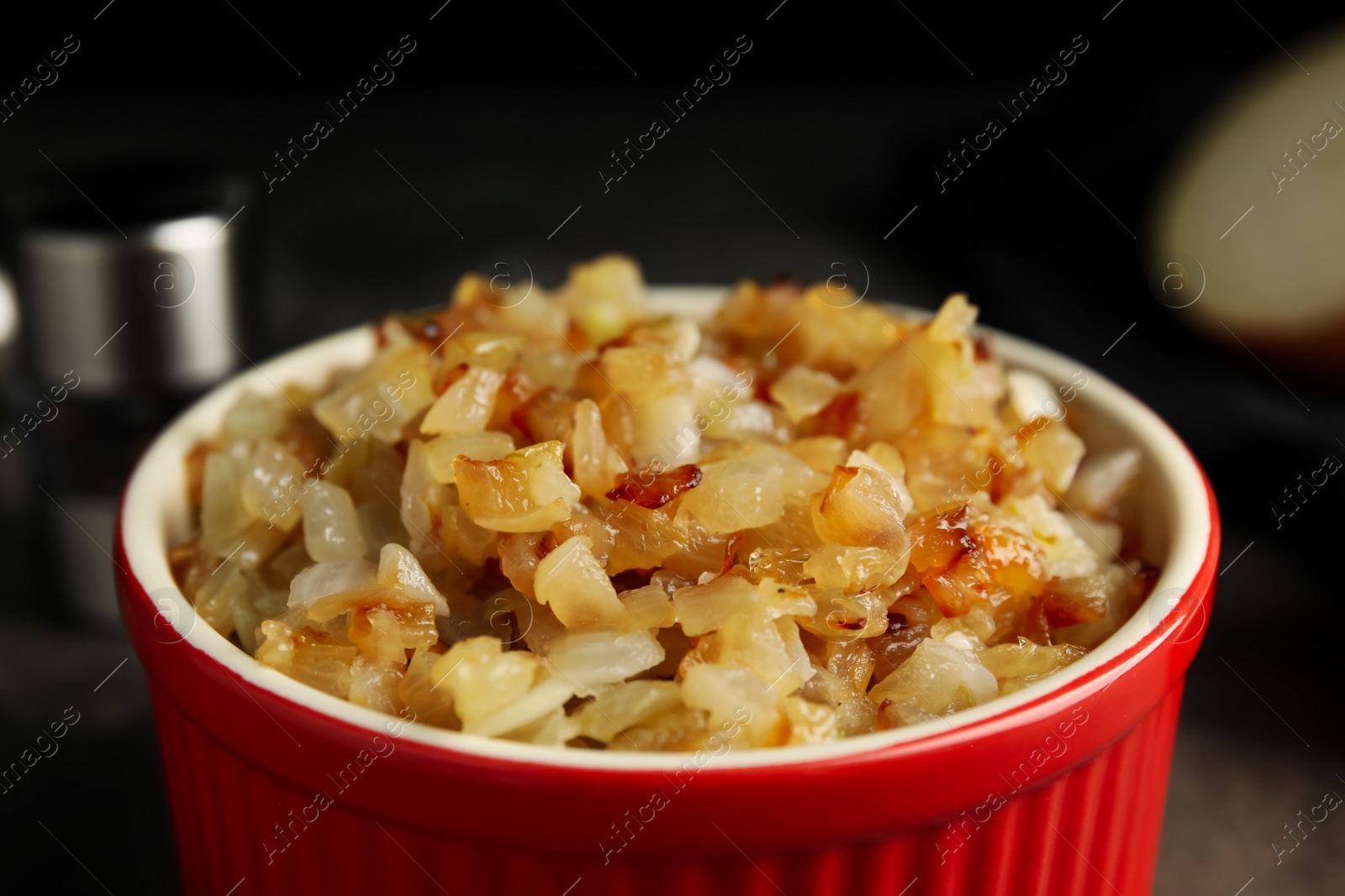 Photo of Tasty fried onion in bowl, closeup view
