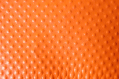 Photo of Texture of orange plastic cup as background, closeup