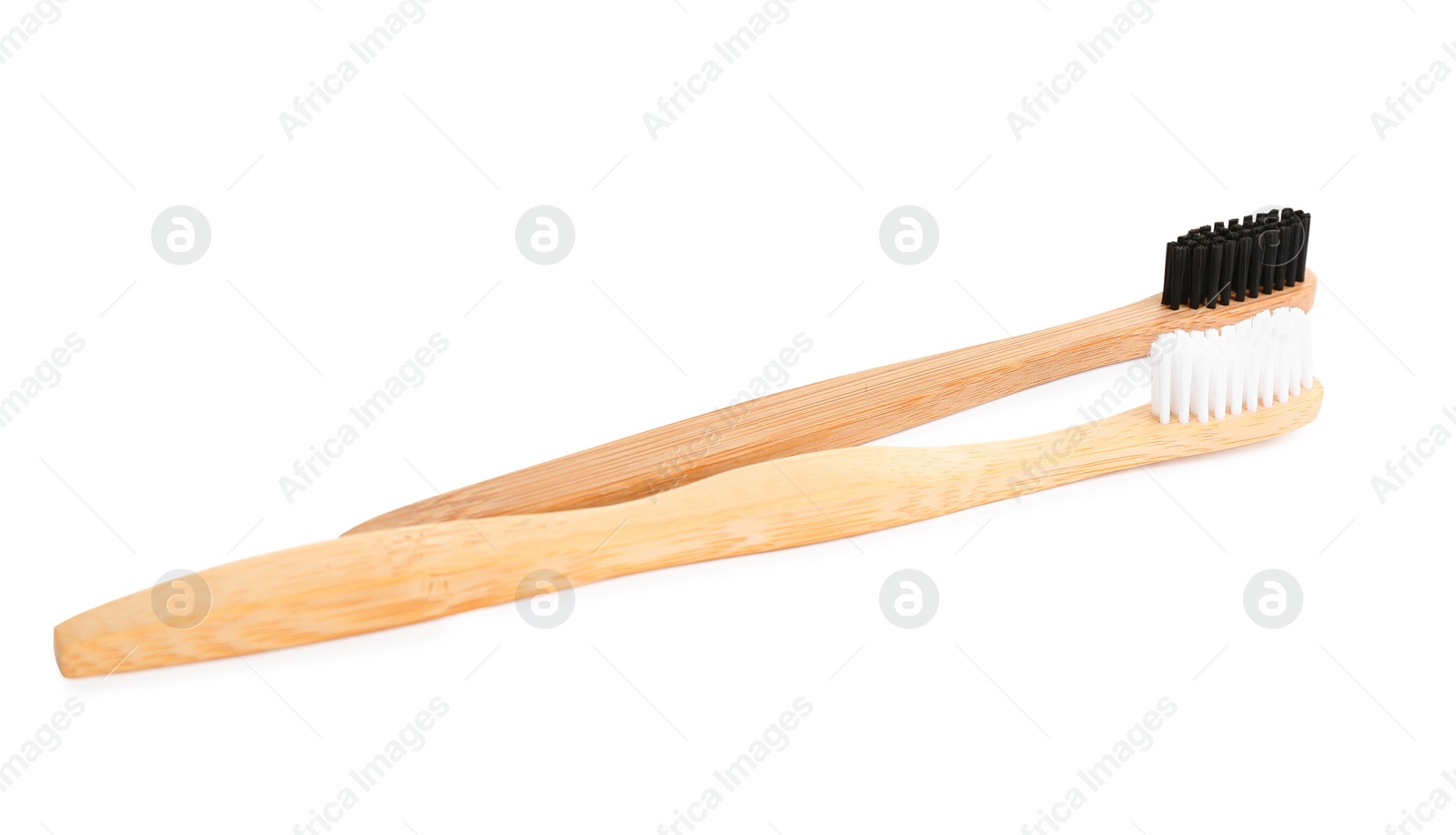 Photo of Natural bamboo toothbrushes with soft bristles isolated on white