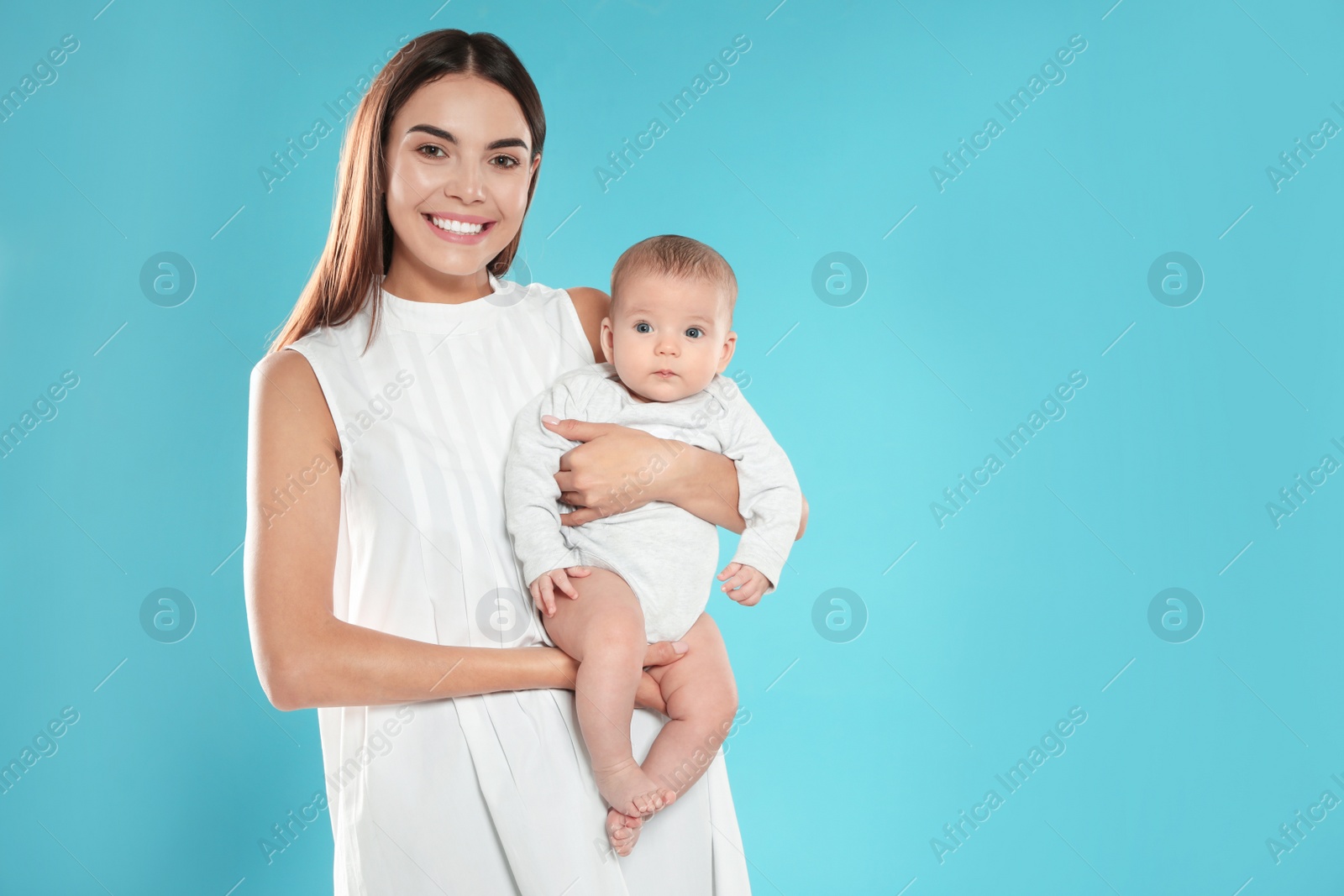 Photo of Portrait of happy mother with her baby on color background. Space for text