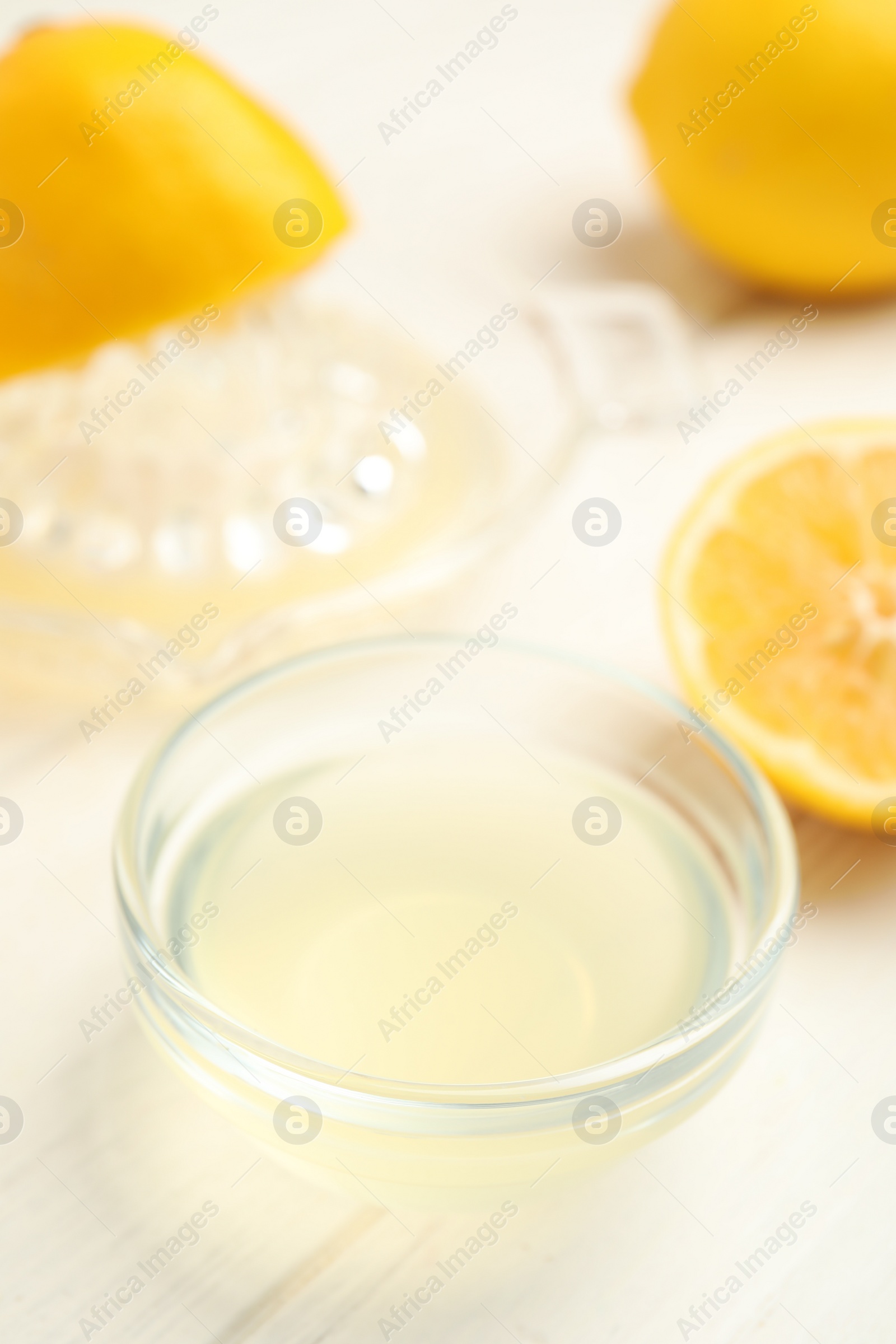 Photo of Freshly squeezed lemon juice on white table