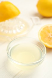 Photo of Freshly squeezed lemon juice on white table