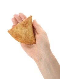 Woman holding fresh delicious crispy samosa on white background, closeup