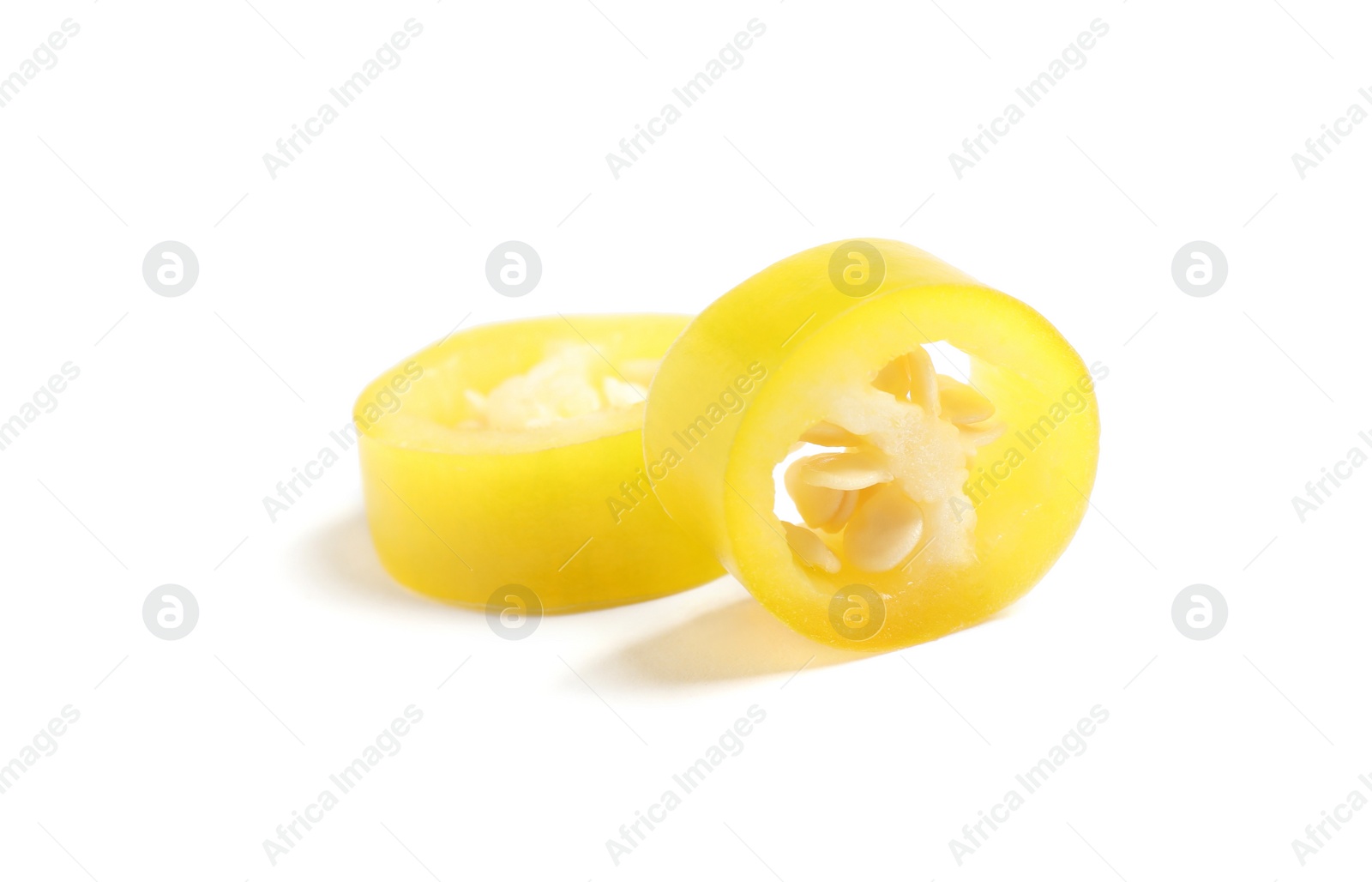 Photo of Cut ripe yellow chili pepper isolated on white