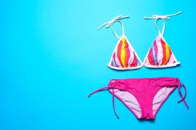 Photo of Stylish bikini on color background, top view