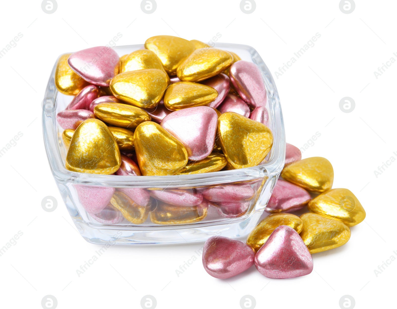 Photo of Glass bowl and many delicious heart shaped candies on white background