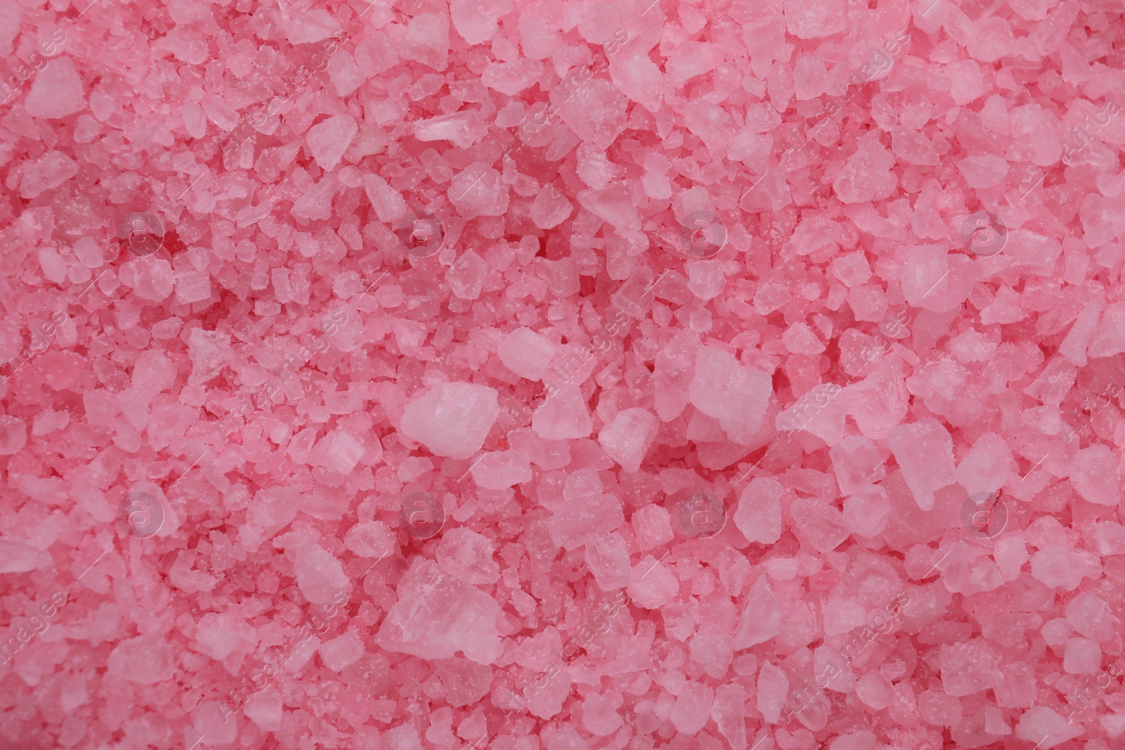 Photo of Pink sea salt as background, top view