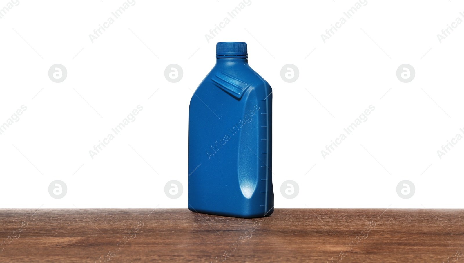 Photo of Motor oil in blue container on wooden table against white background