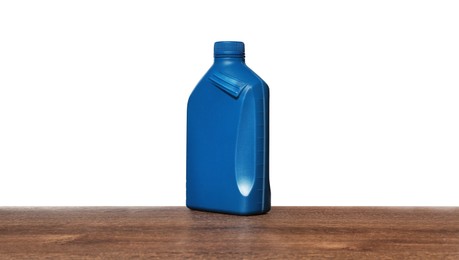 Motor oil in blue container on wooden table against white background