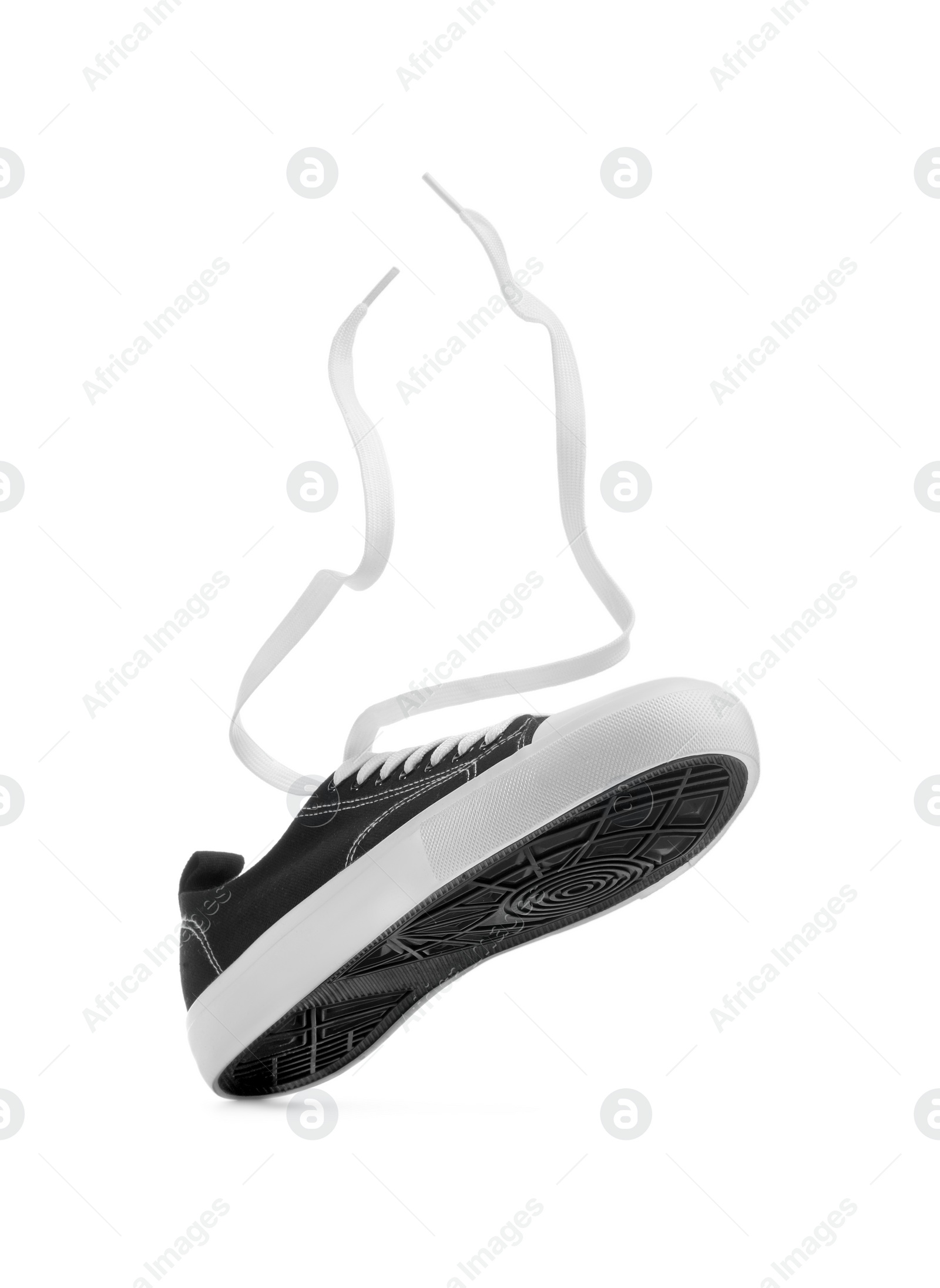 Photo of One black classic old school sneaker isolated on white