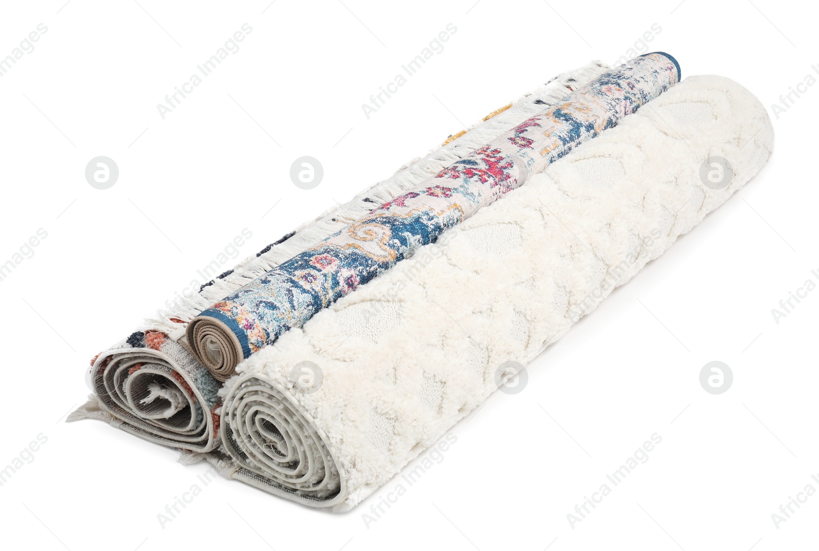 Photo of Rolled carpets on white background. Interior element