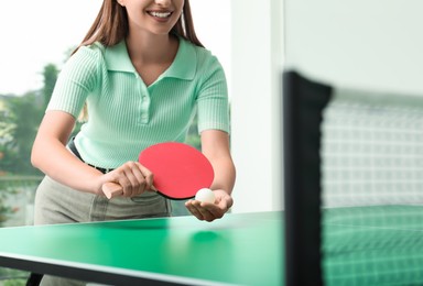 Woman playing ping pong indoors, closeup view. Space for text