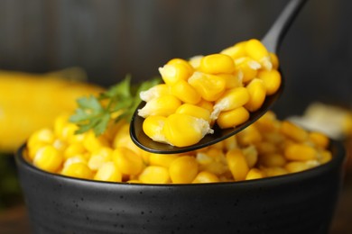 Spoon with tasty boiled corn, closeup view