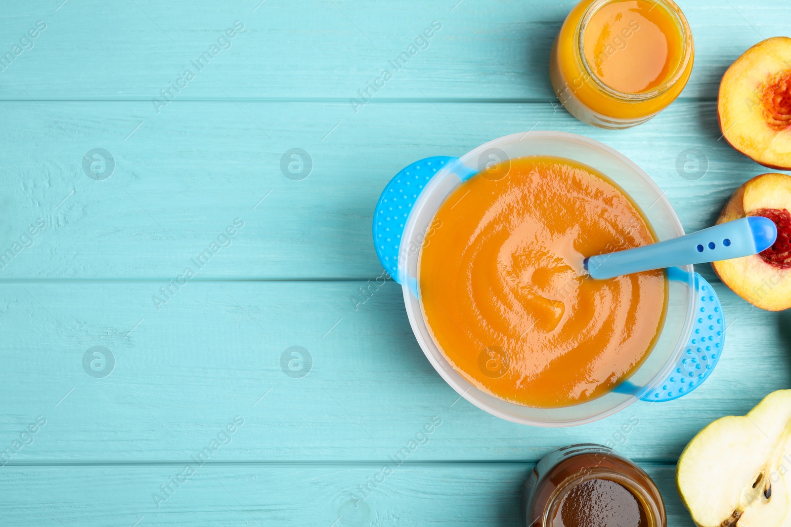 Photo of Flat lay composition with healthy baby food and ingredients on light blue wooden table. Space for text