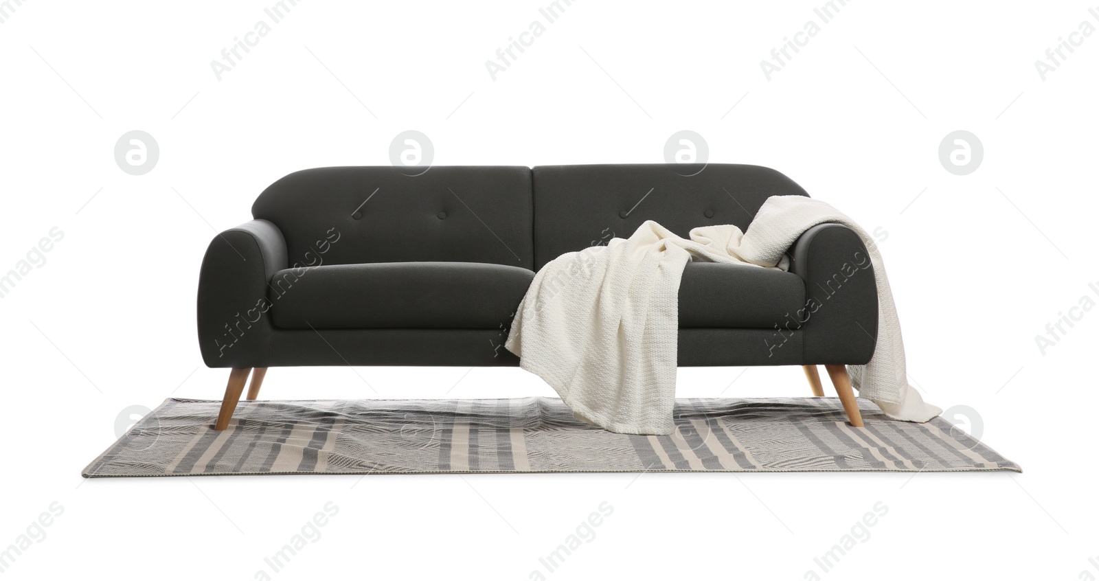 Photo of Comfortable grey sofa with blanket and carpet on white background. Furniture for living room interior