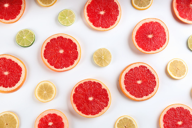 Photo of Flat lay composition with tasty ripe grapefruit slices on white background