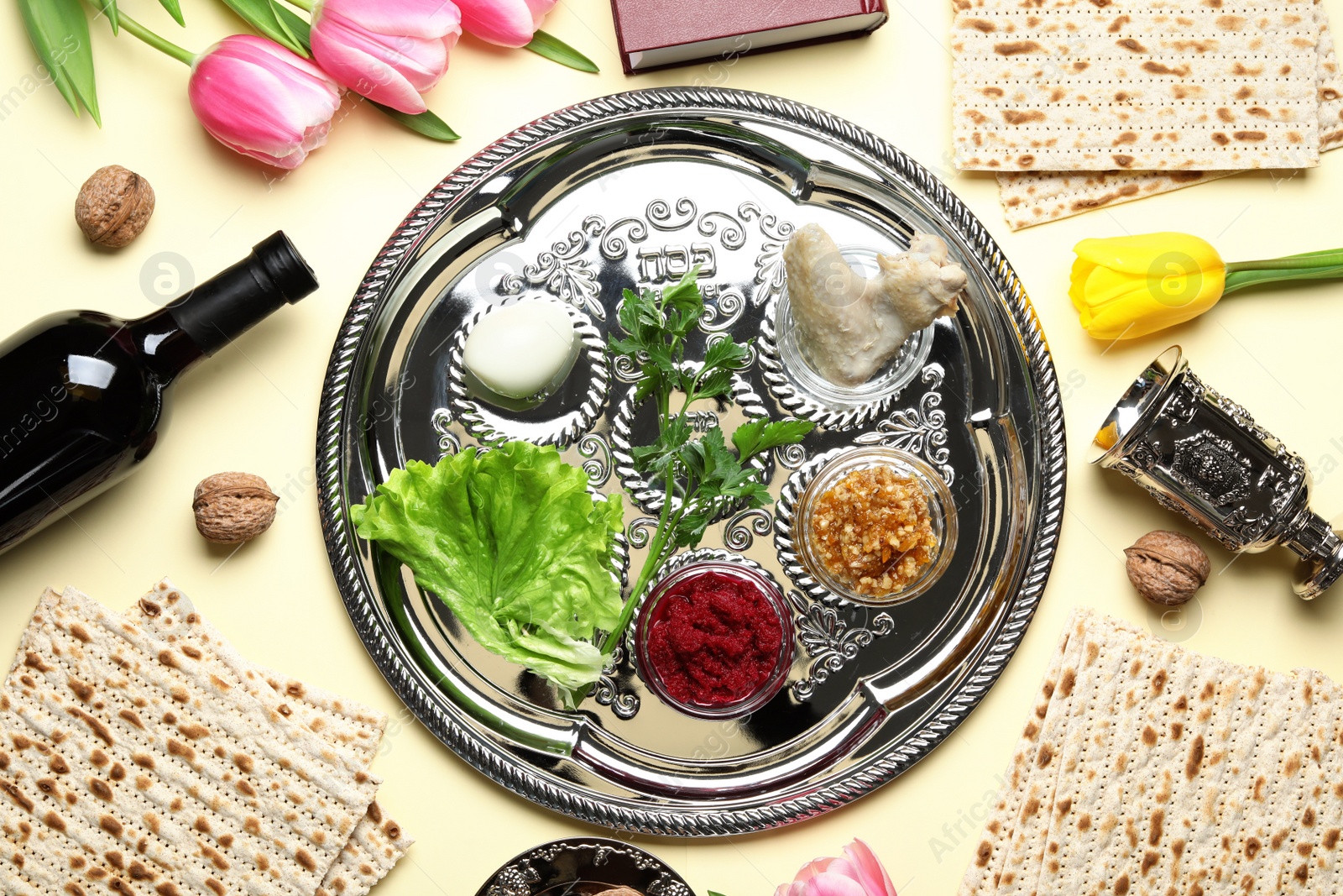 Photo of Flat lay composition with symbolic Passover (Pesach) items and meal on color background