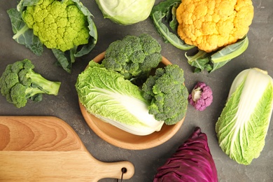 Photo of Different fresh cabbages on table, top view. Healthy food