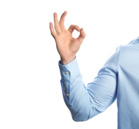 Photo of Young man showing OK gesture on white background