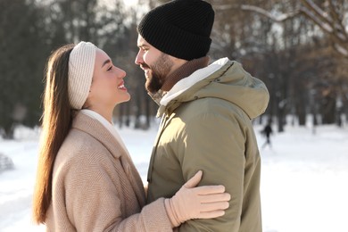 Photo of Beautiful happy couple in snowy park on winter day