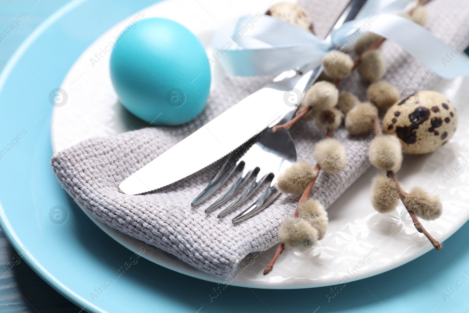 Photo of Festive Easter table setting with eggs, closeup