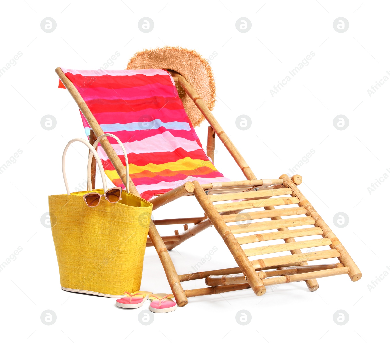 Photo of Wooden sunbed with beach accessories on white background