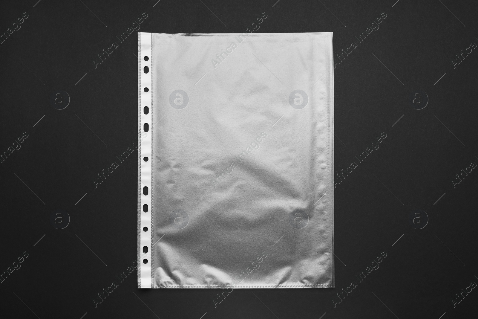 Photo of Punched pocket on black background, top view