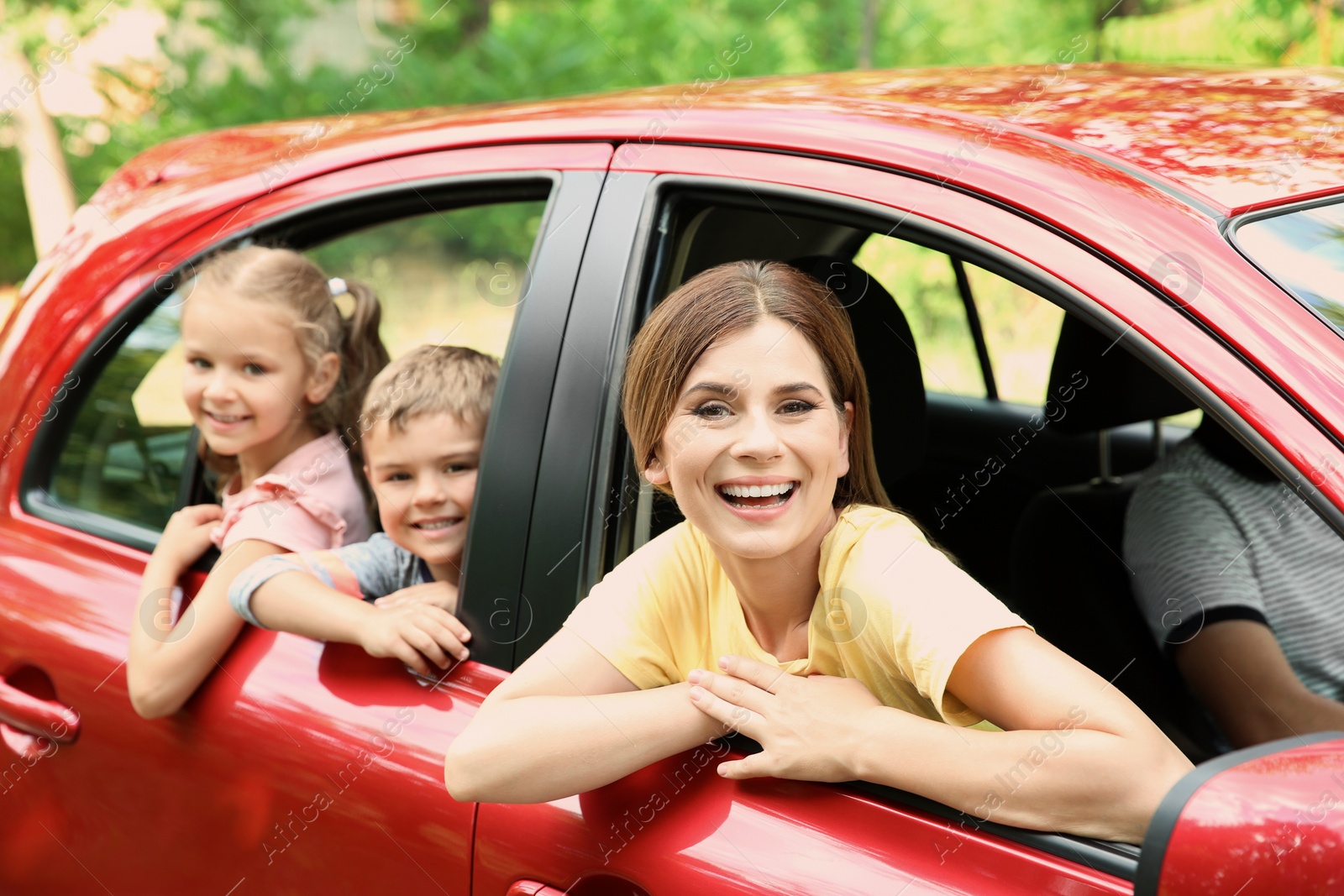 Photo of Happy family with children taking road trip together