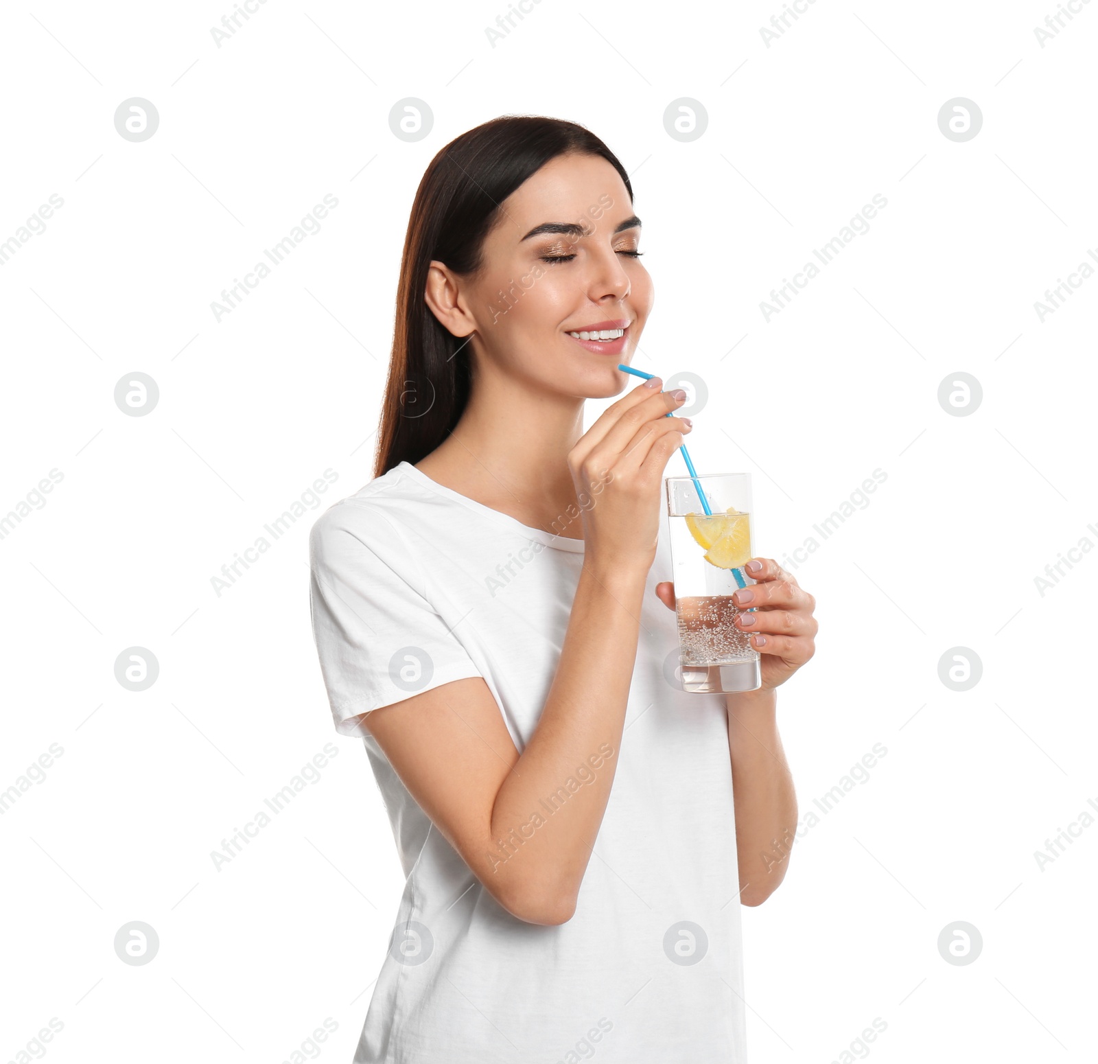 Photo of Beautiful young woman drinking tasty lemon water on white background